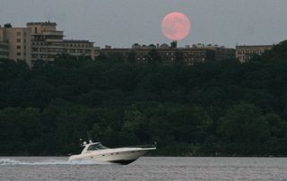 Our own Executive Producer of the Visual Content Team, Dave Brody, caught the supermoon as a powerboat went speeding by over the Hudson river. The supermoon hangs over western Manhattan on August 10, 2014.