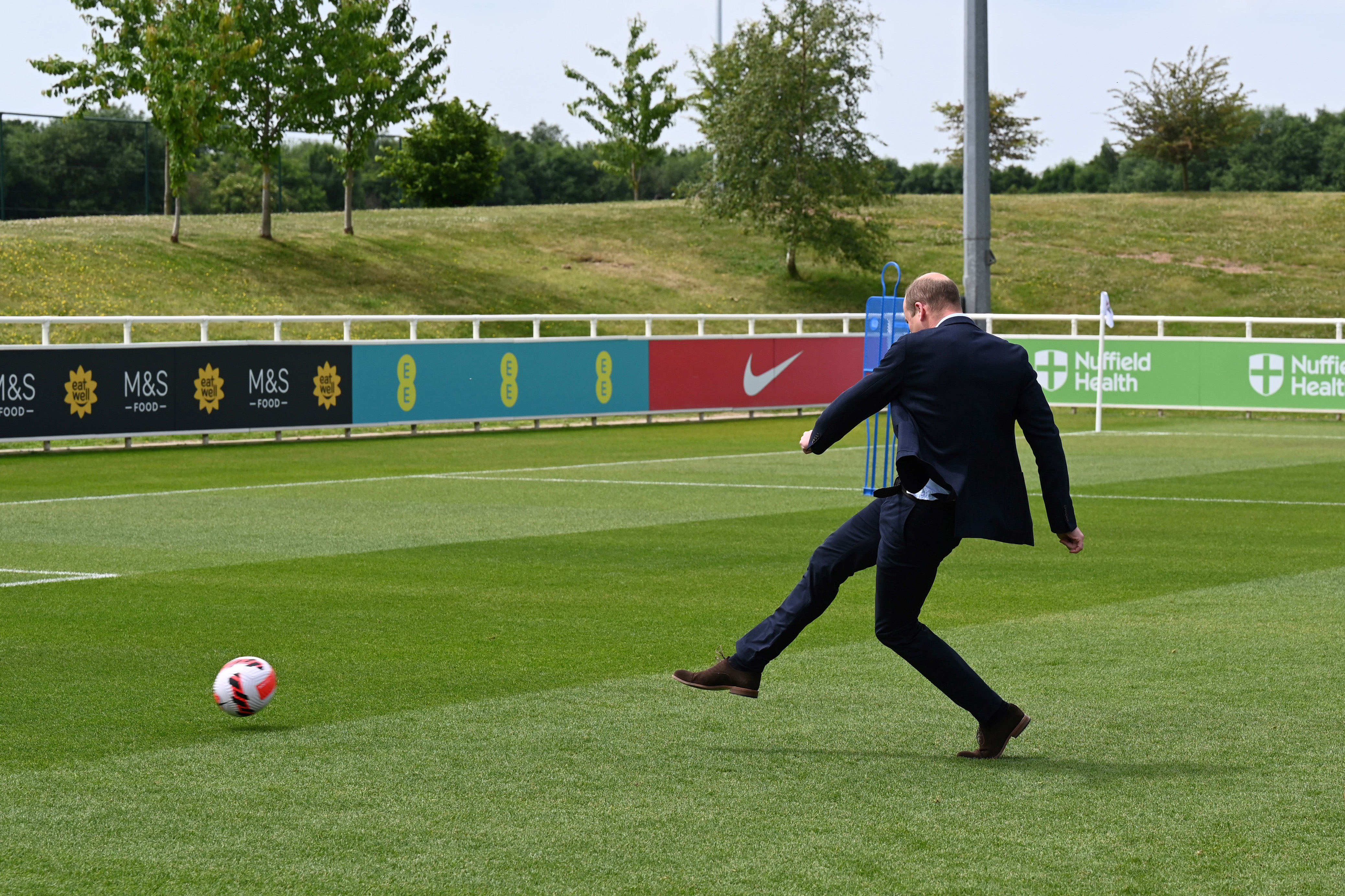 Prince William kicking a soccer ball