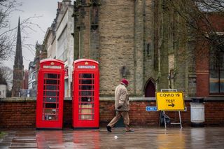 A man walks past a Covid-19 testing center in Southport, United Kingdom, on Feb. 2, 2021. 