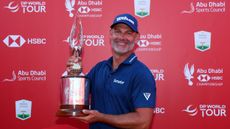 Paul Waring smiles as he poses with the 2024 Abu Dhabi HSBC Championship