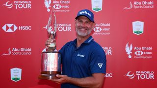 Paul Waring smiles as he poses with the 2024 Abu Dhabi HSBC Championship