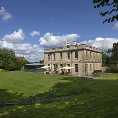 brown building with grass lawn