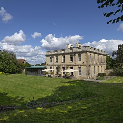 brown building with grass lawn