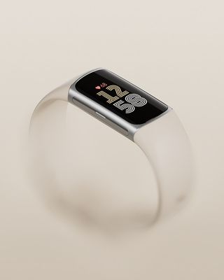 The Fitbit Charge 6 in silver with a Porcelain Infinity band.