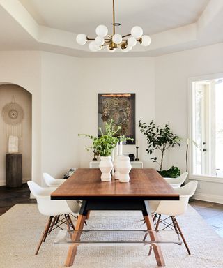 dining room with white walls and wooden table with white chairs