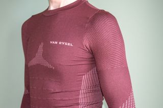 A man wearing the Van Rysel Long Sleeve Racer 2 base layer