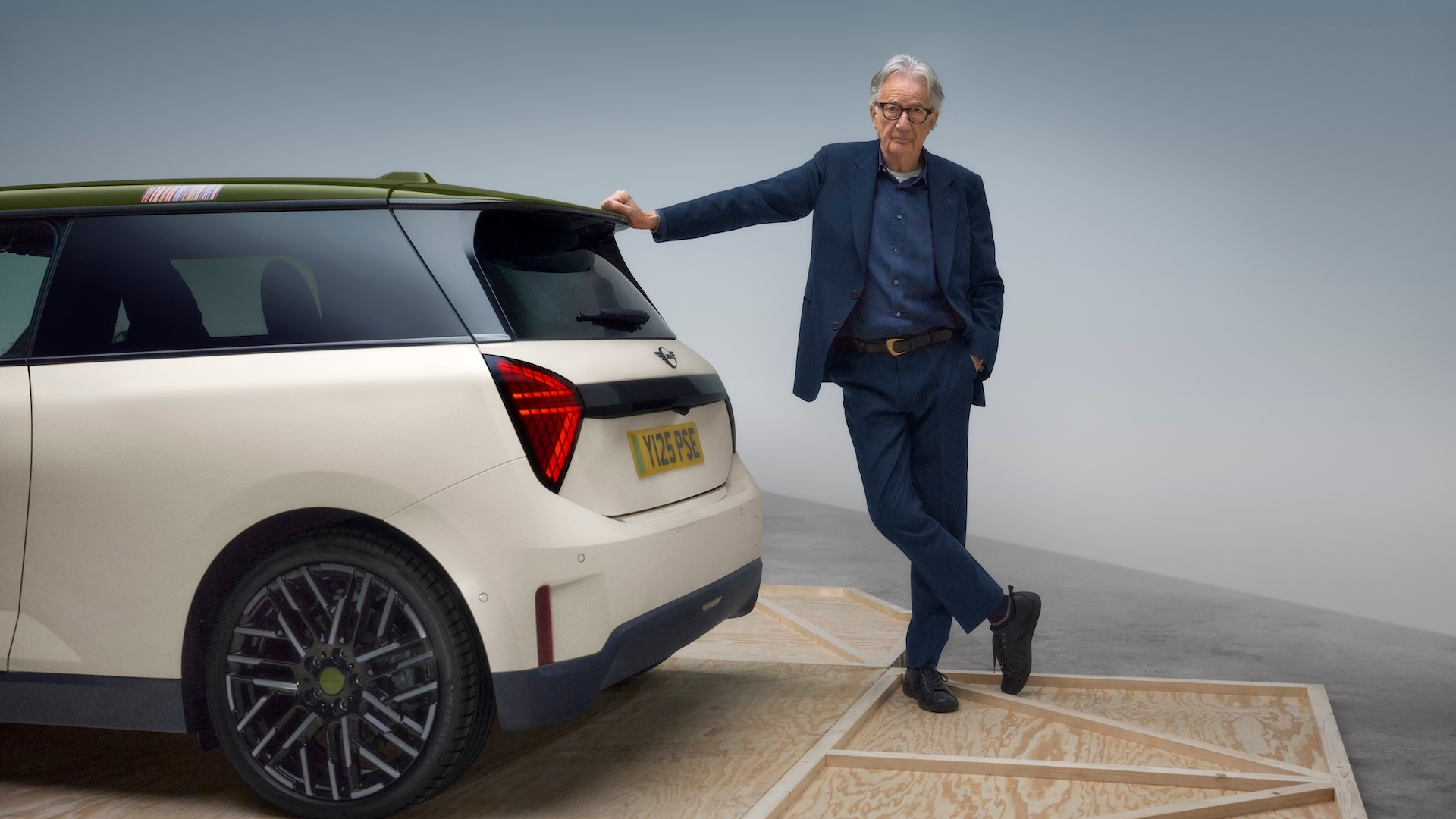 Sir Paul Smith leaning on a Mini