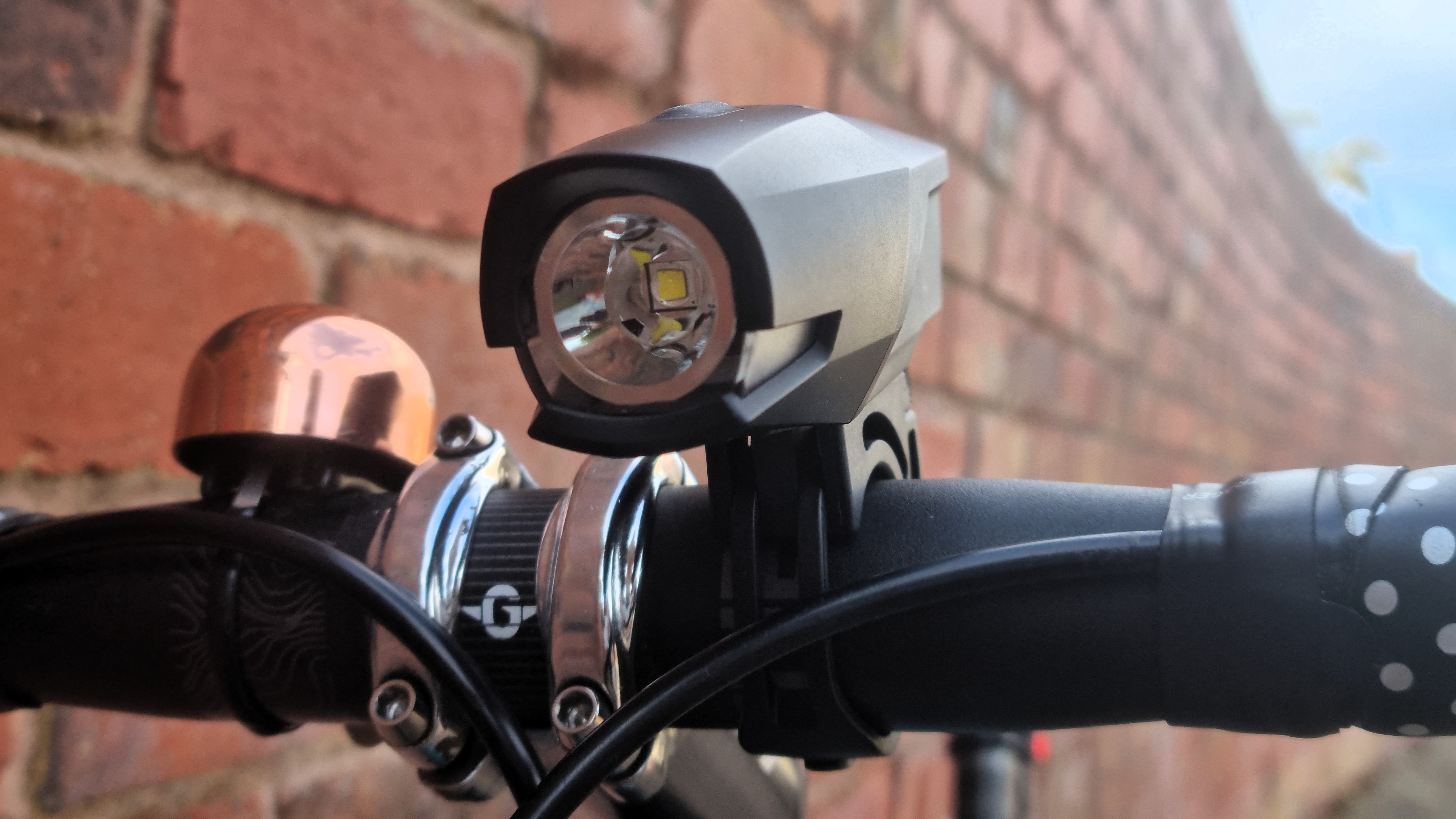 A close up of the PDW City Rover 700 front light, mounted to a handlebar and seen from the front