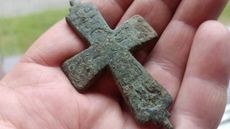 A person holding a cross 
