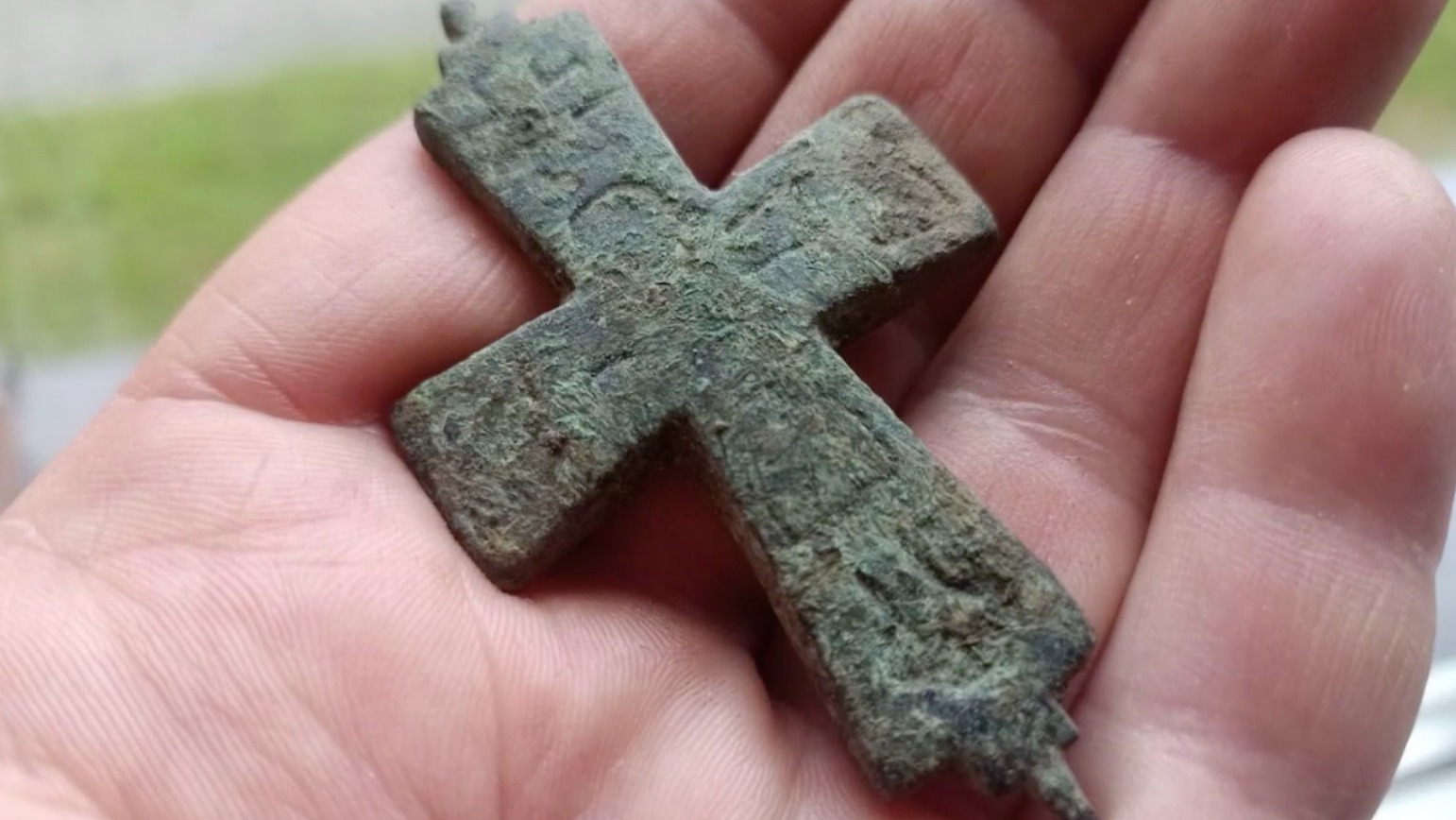 A person holding a cross in their hand