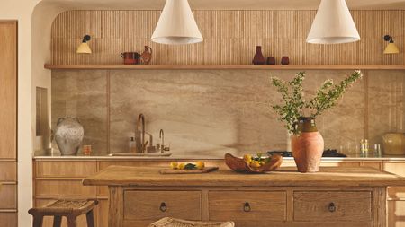 A Tuscan-inspired kitchen with a marble backsplash and a wooden freestanding island