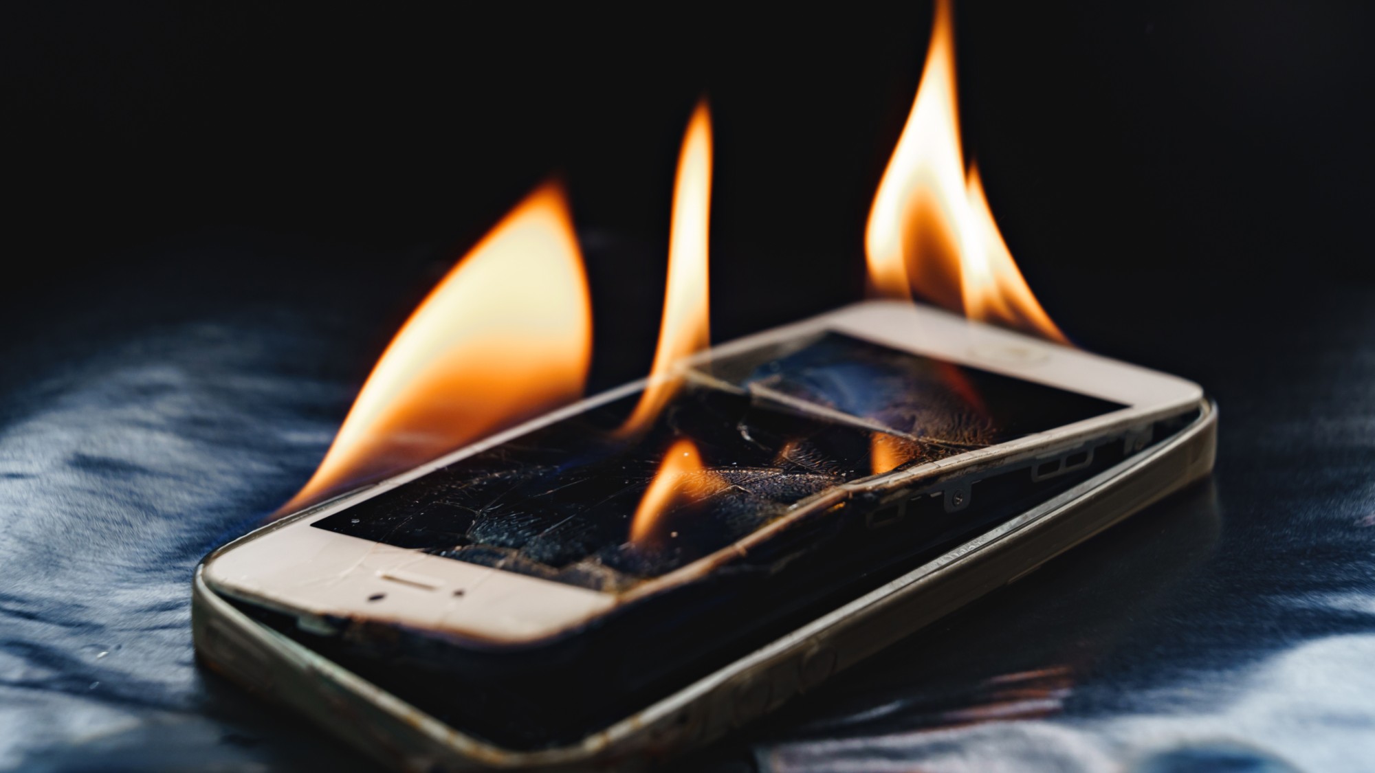 A stock photo of a smartphone that is on fire. 