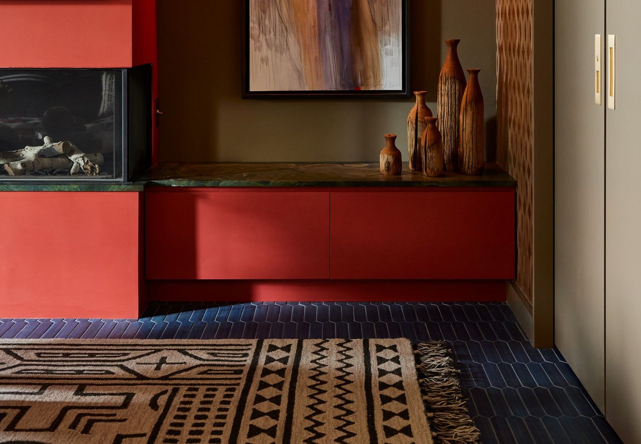 A living room with a rug placed on top of a carpet