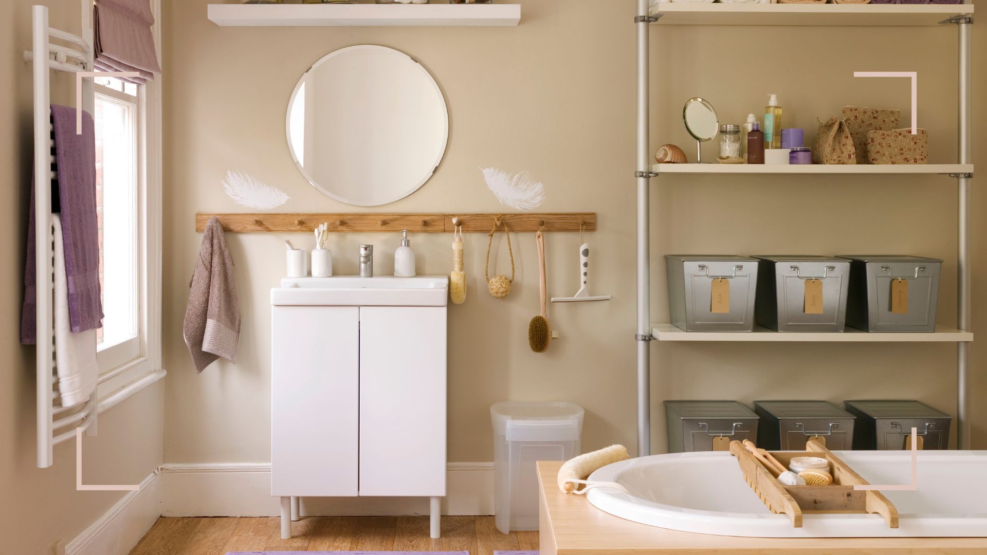 Beige bathroom with a white vanity unit with a circular mirror with a framed wall-mounted storage unit