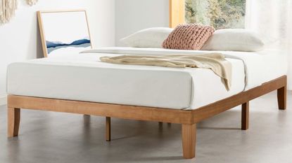White bed on wooden frame