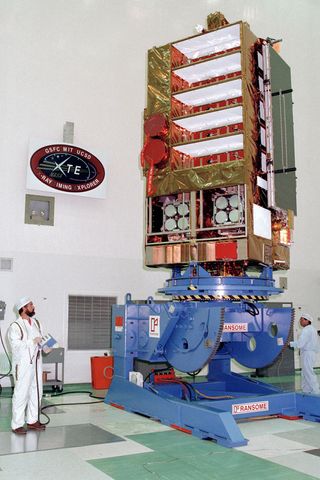 NASA's Rossi X-ray Timing Explorer satellite, shown here during prelaunch checks in 1995, was built to study the time variation of X-ray sources in space.