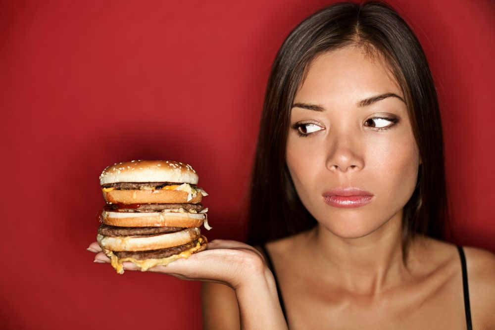 A woman hungrily eyes a giant burger