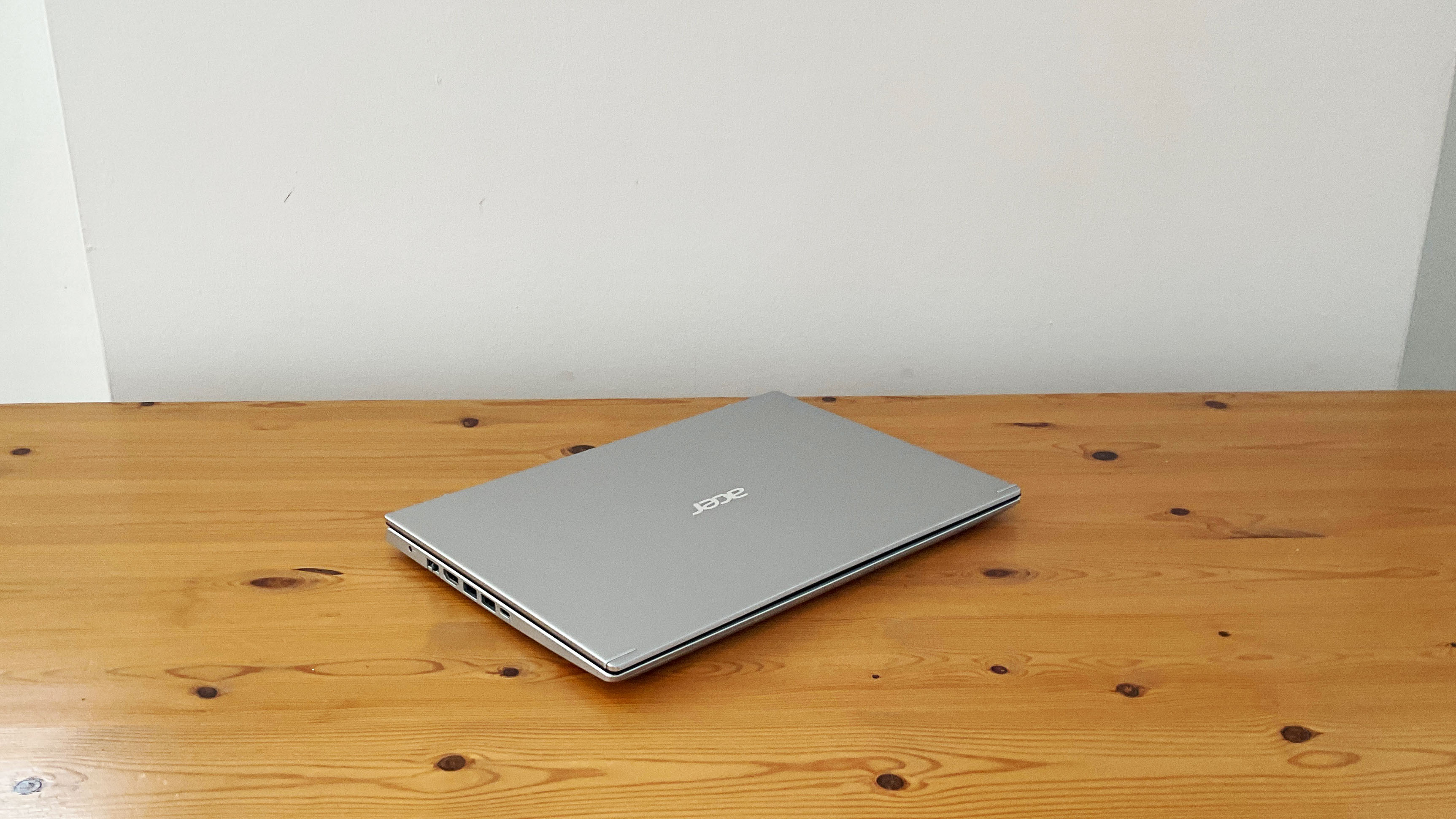Acer Aspire 5 laptop on desk, lid closed.