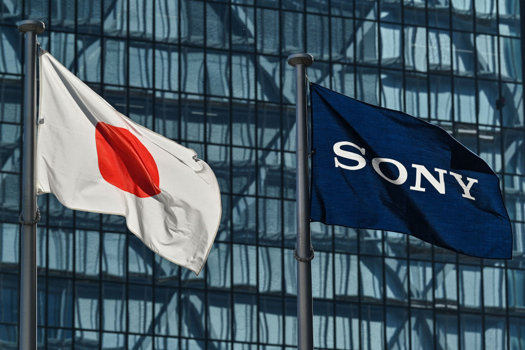 Japanese and Sony flags fly outside the company's headquarters in Tokyo on February