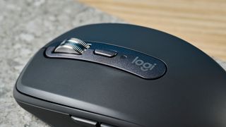 A photo of the Logitech MX Anywhere 3S mouse on a stone surface.