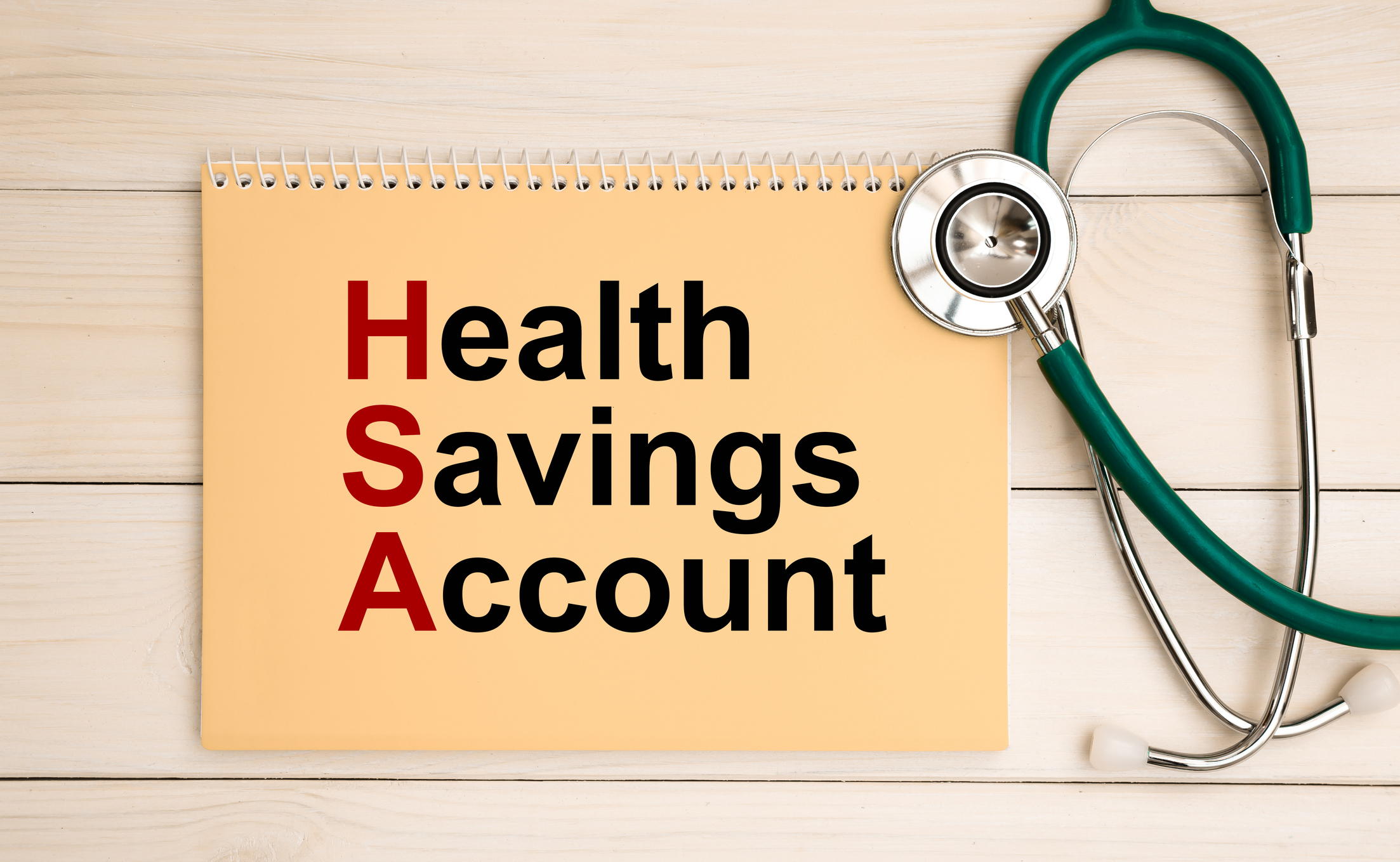 Notepad with text Health Savings Account HSA and stethoscope. Medical concept.