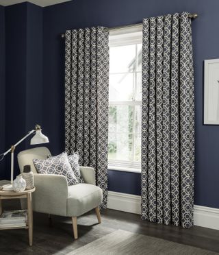 patterned curtains in a living room with blue walls