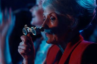 Mrs Flood in Doctor Who looking through binoculars 