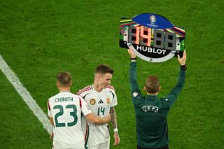 Kevin Csoboth of Hungary embraces Bendeguz Bolla as he leaves the field during a substitution during the UEFA EURO 2024 group stage match between Scotland and Hungary at Stuttgart Arena on June 23, 2024 in Stuttgart, Germany. (Photo by Clive Mason/Getty Images)