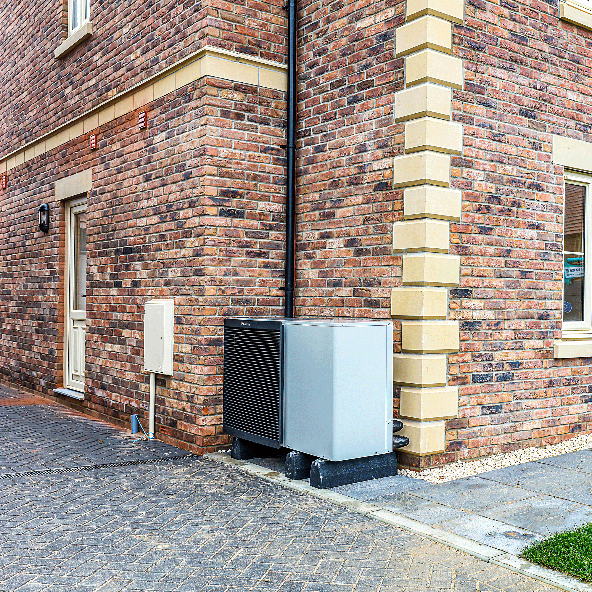 Heat source air pump outside brick wall