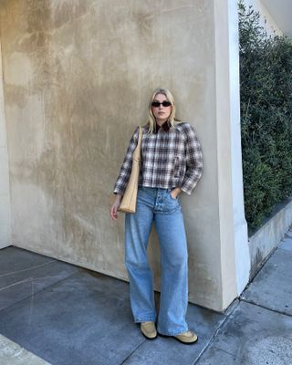 Natalie wears plaid jacket, tote, wide-leg jeans, and boat shoes.