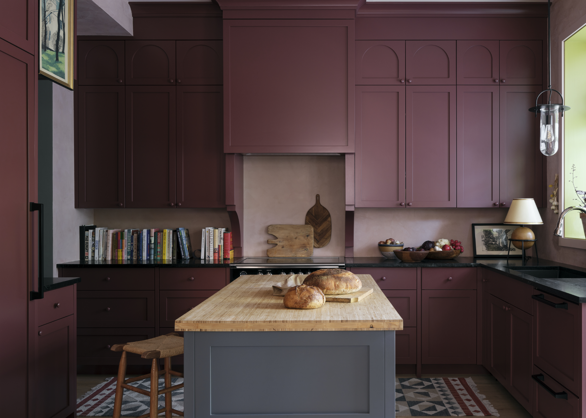 a red kitchen with a green accent window reveal