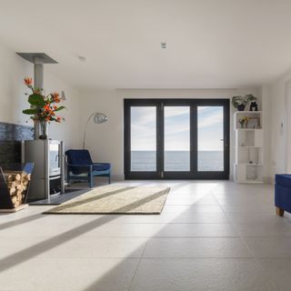 living room with white wall and rug