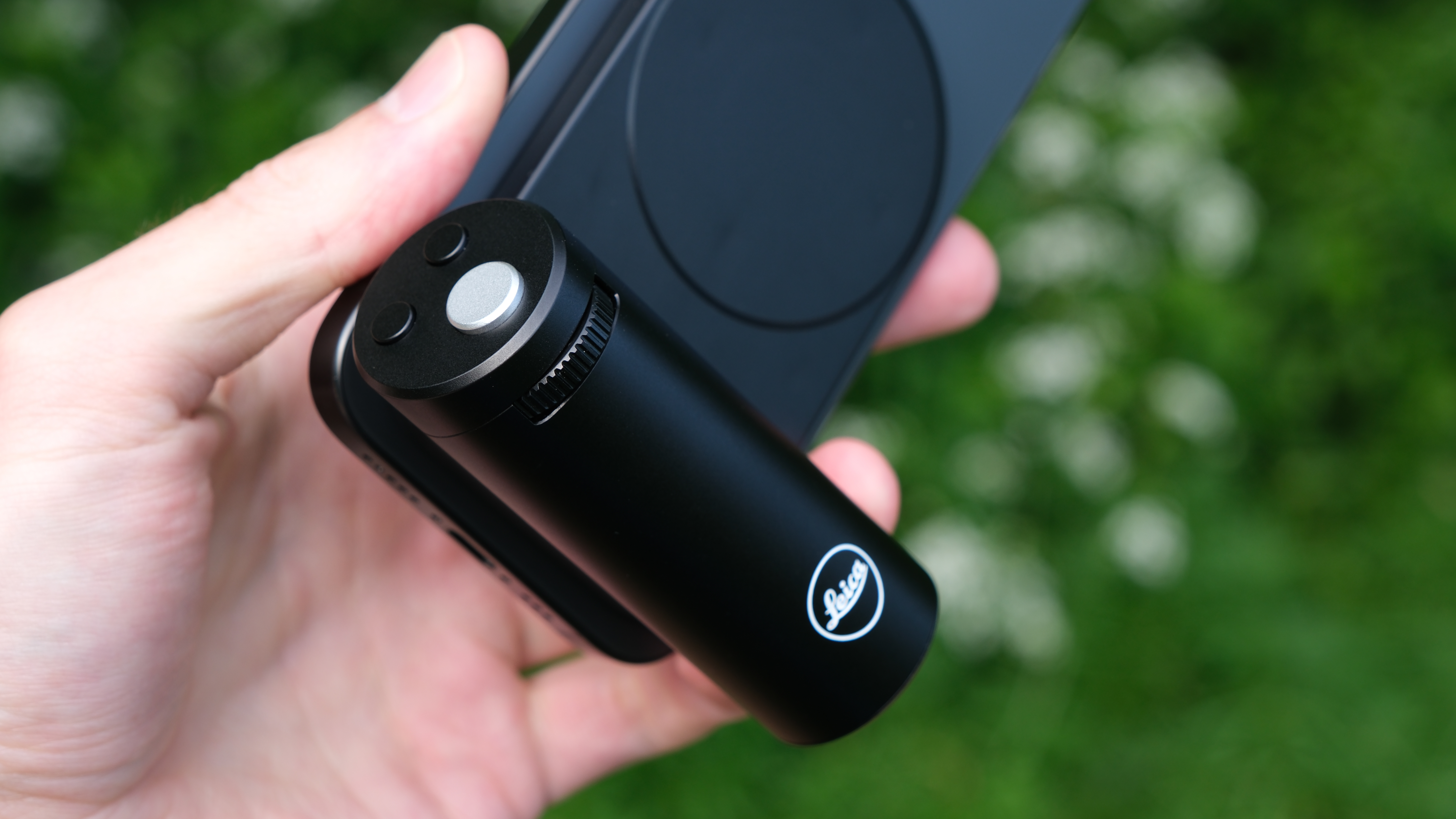 Leica Lux Grip attached to an iPhone and held in a hand