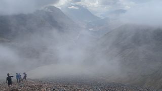 Mountain runners in the clouds