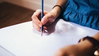 Woman drawing on a piece of paper