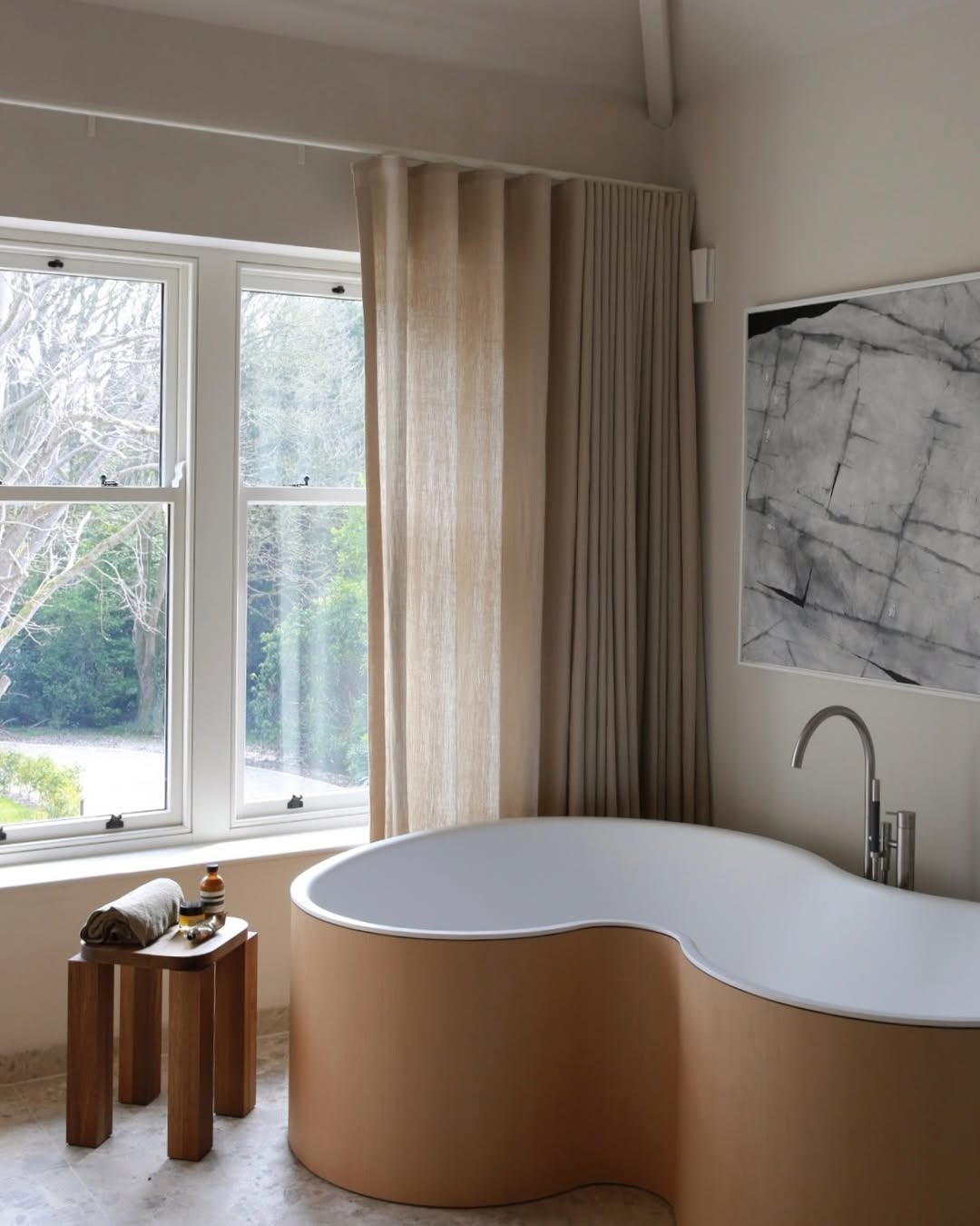 Wood bathtub with a dark wood side table