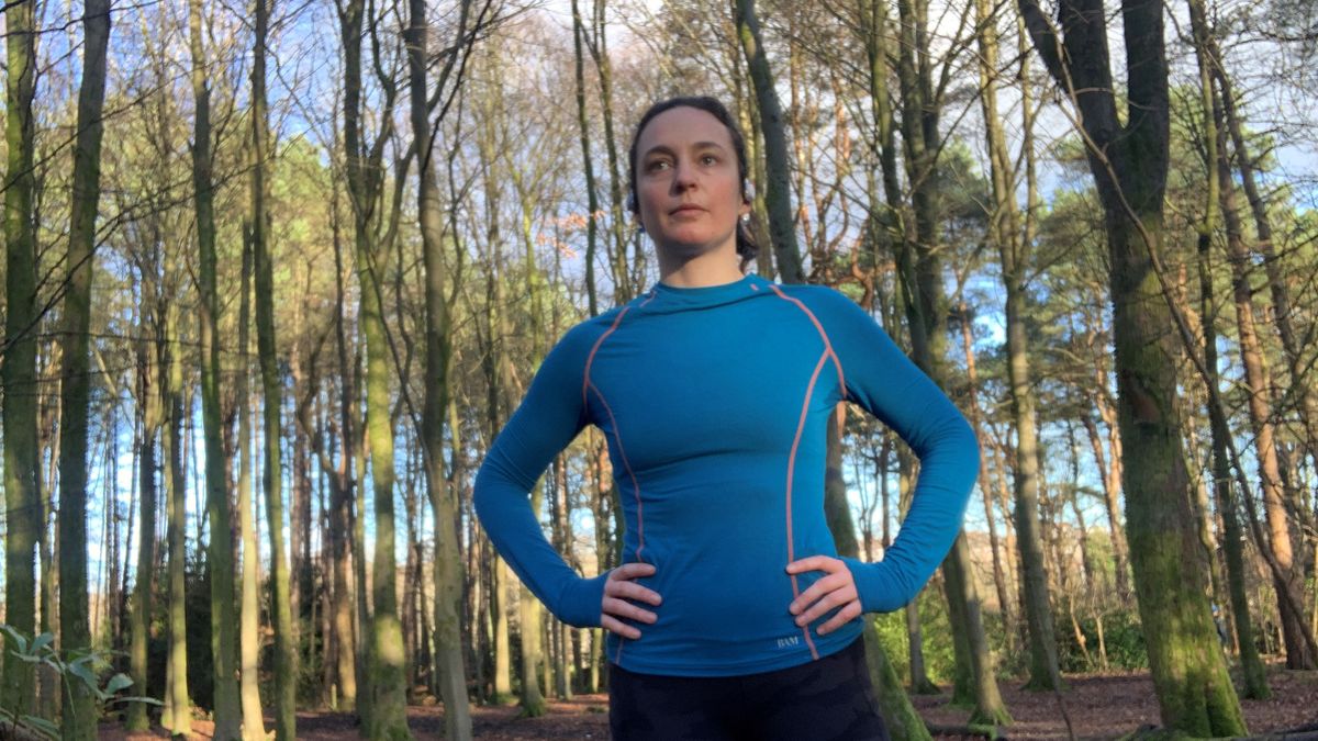 Julia Clarke wearing a blue base layer in the forest