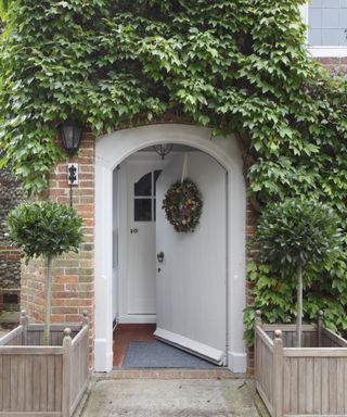 White painted front door with ivy