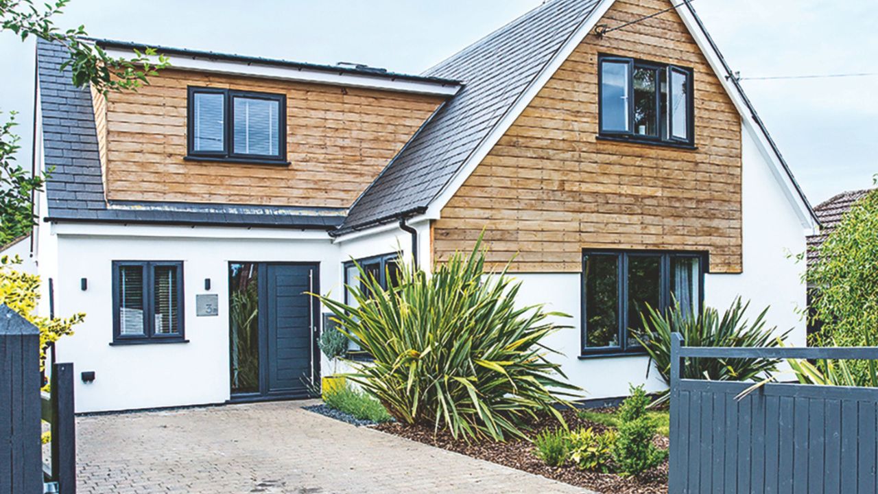 Grey framed windows in extended bungalow complement the clad and rendered external facade