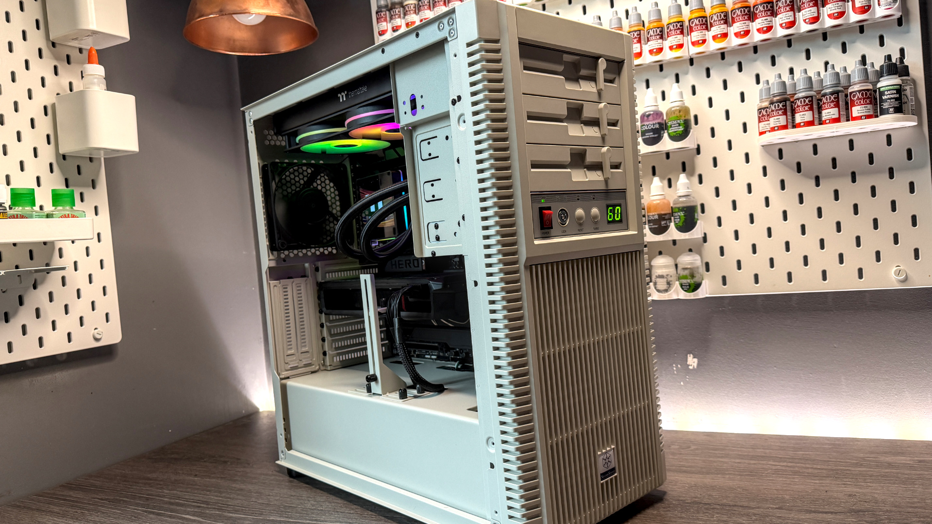 The retro-styled Silverstone FLP02 PC case as a PC is being built into it on a desk.