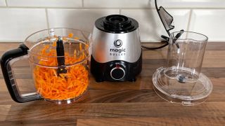 Nutribullet Magic Bullet Kitchen Express on a kitchen countertop with grated carrot in the food processor bowl having just been prepared