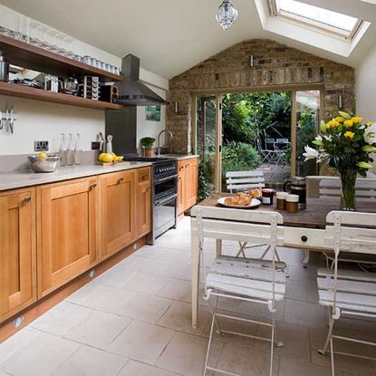 kitchen room with tiled flooring and kitchen cabinets