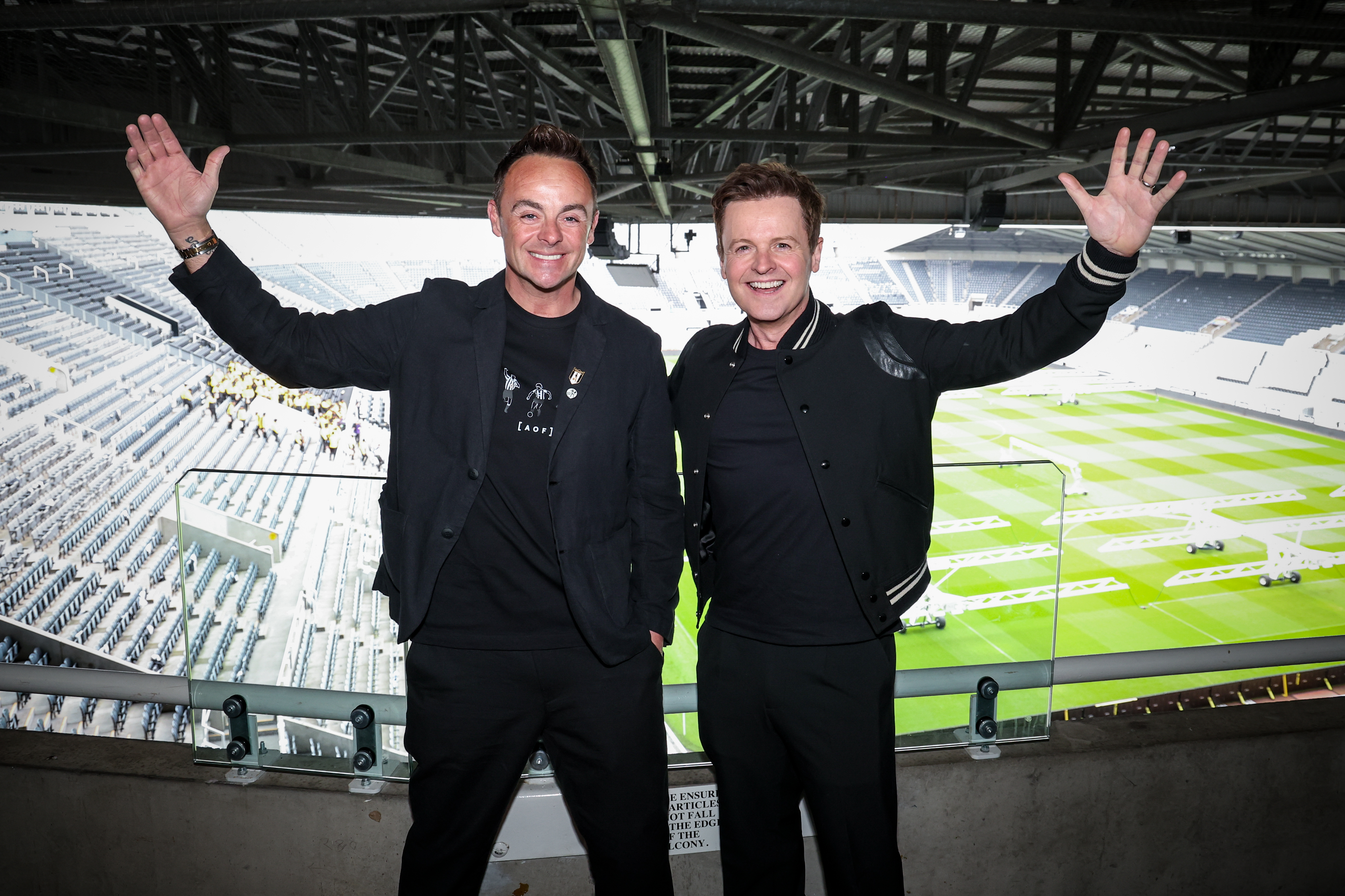 NEWCASTLE UPON TYNE, ENGLAND - MARCH 29: Ant and Dec (Anthony McPartlin, Declan Donnelly) wave at St. James' Park during the Newcastle United trophy parade and celebration on March 29, 2025 in Newcastle upon Tyne, England. Newcastle United defeated Liverpool in the Carabao Cup Final to end their seventy-year domestic trophy drought. 