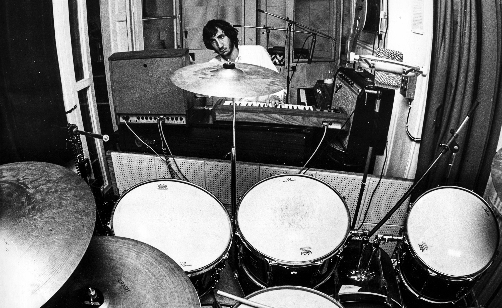 Townshend, guitarist with The Who posed with keyboards and early synthesisers and a drum kit in his home recording studio in 1969.