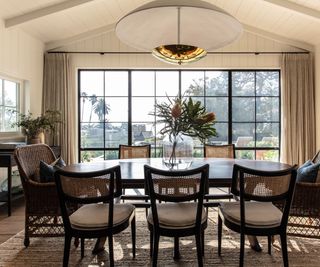 dining room with huge steel framed window and vaulted ceiling