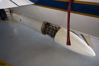 Sample collection canisters are seen in a pod mounted to NASA's ER-2 high-altitude aircraft, part of the SEAC4RS airborne science mission.