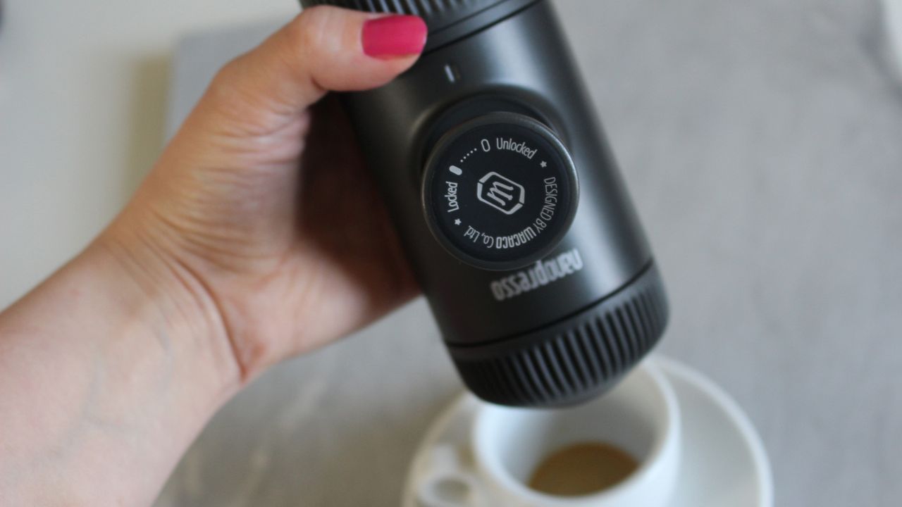 Person using Wacaco Nanopresso coffee maker