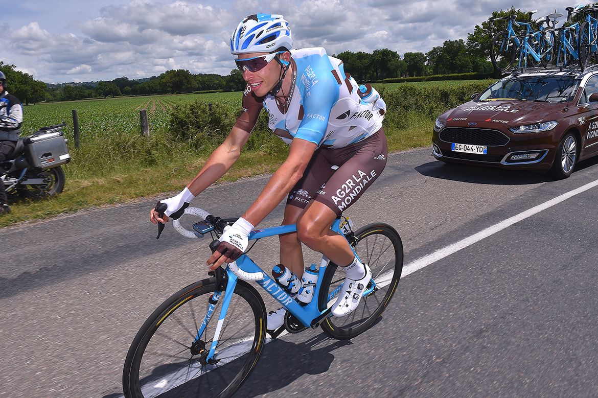Oliver Naesen carries as many bidons as he can in his jersey