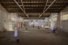 Melbourne Design Week 2024 exhibition with squiggly neon light installations in an industrial space