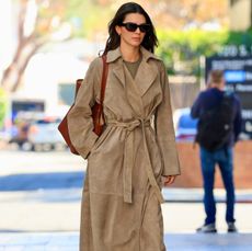 Kendall Jenner in sude trench coat and blue jeans in a minimalist quiet luxury outfit